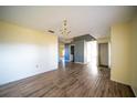 Living room with wood-look floors and neutral walls at 266 Vervain Ave, Davenport, FL 33837