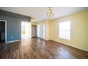 Living room with wood-look floors and neutral walls at 266 Vervain Ave, Davenport, FL 33837