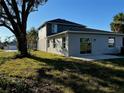 Two-story house back view, with sliding glass doors leading to a patio at 2903 Travelers Palm Dr, Edgewater, FL 32141