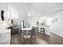 Open living and dining area with gray sofa and hardwood floors at 3900 Southpointe Dr # 127, Orlando, FL 32822