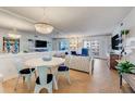Bright living room with coastal decor, hardwood floors, and a dining area at 4153 S Atlantic Ave # 3070, New Smyrna Beach, FL 32169