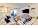 Living room with coastal decor, hardwood floors, and sliding glass doors to balcony at 4153 S Atlantic Ave # 3070, New Smyrna Beach, FL 32169