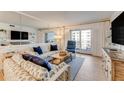 Living room with coastal decor, hardwood floors, and balcony access at 4153 S Atlantic Ave # 3070, New Smyrna Beach, FL 32169