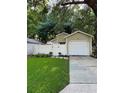 House exterior showcasing a white garage door and a neatly kept lawn at 513 Harvard Pl, Apopka, FL 32703