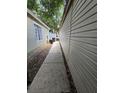 Sidewalk alongside the house, providing convenient access at 513 Harvard Pl, Apopka, FL 32703