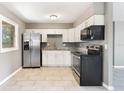 Renovated kitchen featuring stainless steel appliances and white cabinets at 540 Fern Ave, Tavares, FL 32778