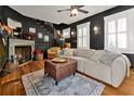 Living room with a fireplace, hardwood floors, and ample seating at 606 E Amelia St, Orlando, FL 32803