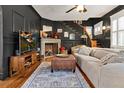 Spacious living room featuring a fireplace, hardwood floors, and a comfy sofa at 606 E Amelia St, Orlando, FL 32803