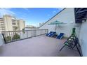 Private balcony with lounge chairs and city views at 6165 Carrier Dr # 3707, Orlando, FL 32819