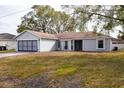 Gray house with attached garage and a large front yard at 741 Caribou Dr, Kissimmee, FL 34759