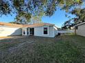 Gray house with a small front yard and screened door at 741 Caribou Dr, Kissimmee, FL 34759
