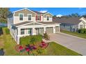 Two-story house with a three-car garage, and a waterfront view at 10249 Spring Lake Dr, Clermont, FL 34711