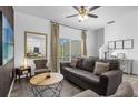 Spacious living room featuring a comfortable couch and large TV at 1041 Las Fuentes Dr, Kissimmee, FL 34746