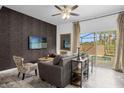 Living room with backyard access, comfy seating, and a large TV at 1041 Las Fuentes Dr, Kissimmee, FL 34746