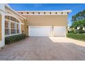 Two-car garage with paver driveway and exterior lighting at 1519 Lake Rhea Dr, Windermere, FL 34786