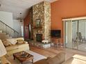 Living room with stone fireplace and wood-paneled ceiling at 1902 Abbington St # 1902, Apopka, FL 32712