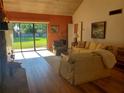 Bright living room with light beige couch and view of backyard at 1902 Abbington St # 1902, Apopka, FL 32712