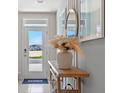Bright and airy entryway with console table, mirror, and pampas grass at 1956 Tamarack Pass, Davenport, FL 33837