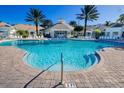 Resort-style pool with plenty of lounge chairs and umbrellas at 2302 Butterfly Palm Way # 102, Kissimmee, FL 34747