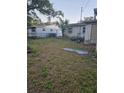 Large backyard with unkempt grass and a chain link fence at 4419 Lake Lawne Ave, Orlando, FL 32808