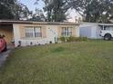 Ranch-style home with a large front yard and mature trees at 4419 Lake Lawne Ave, Orlando, FL 32808