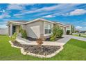 Inviting home exterior with a stone accent, well-manicured landscaping and beautiful lawn and walkways at 4505 Hummingbird Ln, Haines City, FL 33844