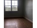 Spacious bedroom with large window and tile flooring at 6413 Astor Village Ave # 314, Orlando, FL 32835