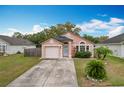 Charming one-story home with a two-car garage and landscaped yard at 9606 Chandon Dr, Orlando, FL 32825