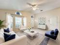 Bright living room with comfy seating and large windows at 9606 Chandon Dr, Orlando, FL 32825
