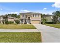 Charming two-story home with stone accents, a well-manicured lawn, and inviting curb appeal at 10097 Leland Dr, Orlando, FL 32827