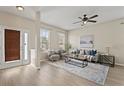 Bright living room with wood floors, neutral walls, lots of light, and comfortable seating at 10097 Leland Dr, Orlando, FL 32827