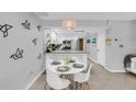 Bright dining area with a round table and four white chairs at 111 N Atlantic Ave # 2090, New Smyrna Beach, FL 32169