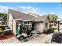 Rear exterior view of house with golf cart at 1339 Villa Ln # 50, Apopka, FL 32712