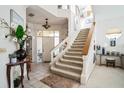 Elegant entryway featuring a grand staircase and decorative accents at 14325 Dulcimer Ct, Orlando, FL 32837