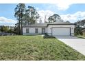Newly built home with gray roof, white exterior, and a spacious lawn at 1608 Airmont Ave, Deltona, FL 32725