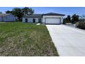Well maintained single Gathering home with white exterior, black accents, paved drive, and manicured lawn at 1608 Airmont Ave, Deltona, FL 32725