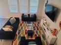Spacious living room with sectional sofa, large TV, and patterned rug at 1706 Chatsworth Cir, Saint Cloud, FL 34771