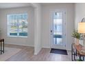 Bright entryway with tile floors, a modern door and a view into the living room at 1914 Summer Serenity Dr, Kissimmee, FL 34744