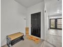 Apartment entry with a black door and welcome mat at 239 Longview Ave # 216, Celebration, FL 34747