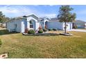 Beautiful single story home with a well-maintained lawn and mature landscaping at 26812 Augusta Springs Cir, Leesburg, FL 34748