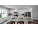 Modern kitchen boasts granite countertops and white cabinetry at 2769 Flushing Dr, Apopka, FL 32703