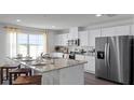 Kitchen features granite island, white cabinets, and stainless steel appliances at 2769 Flushing Dr, Apopka, FL 32703