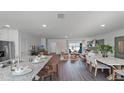 Open kitchen with granite island, stainless steel appliances, and hardwood floors at 2773 Flushing Dr, Apopka, FL 32703