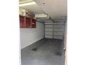 Attached garage with overhead door and shelving at 3017 Cottage Grove Ct # Ge, Orlando, FL 32822