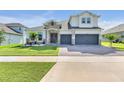 Two-story house with stone accents, three-car garage, and landscaped yard at 4438 Renly Ln, Clermont, FL 34711