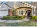Front entrance with brick walkway and landscaping at 5011 Winwood Way, Orlando, FL 32819