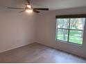 Bright bedroom with wood-look floors and a large window at 5291 Images Cir # 204, Kissimmee, FL 34746