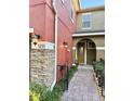 Townhouse entrance with walkway, landscaping, and exterior lighting at 9235 Sweet Maple Ave, Orlando, FL 32832