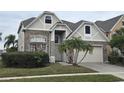 Two-story house with stone accents and a three-car garage at 1108 Darnaby Way, Orlando, FL 32824