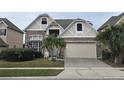 Charming two-story home featuring a well-manicured lawn, a brick-paved driveway, and stone veneer at 1108 Darnaby Way, Orlando, FL 32824